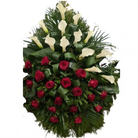 A funeral wreath of white callas and red roses