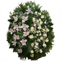 A funeral wreath of white roses, lisianthus and orchids